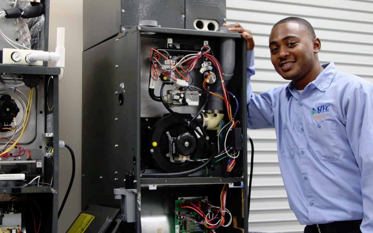HVAC technician servicing an air conditioning unit