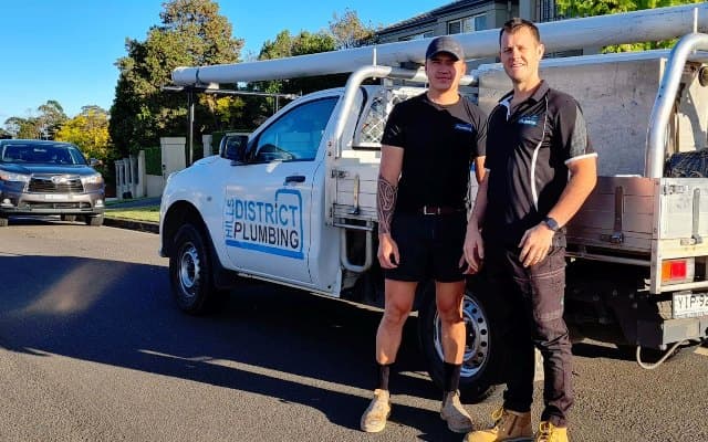 Plumbing service van at a home; water heater service in the neighborhood